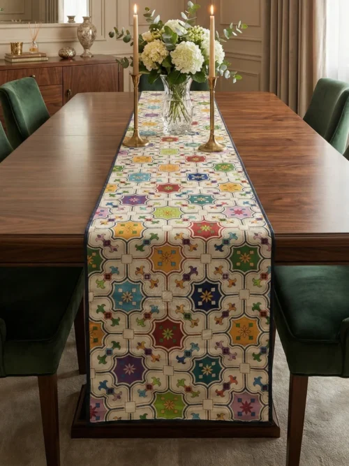 Mughal geometric jharokha table runner placed on a wooden dining table with upholstered green chairs