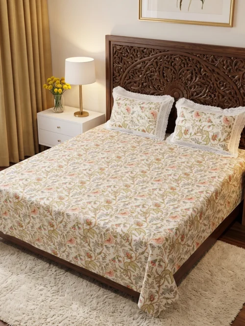 Amber Vine floral cotton bedsheet king size in cream with peach blooms on a carved wooden bed