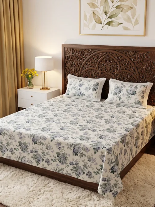 Moonlit Rose blue floral print bedsheet king size in cream with dusty blue roses on a carved wooden bed